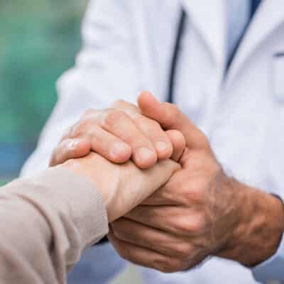 Doctor Holding Patient's Hand