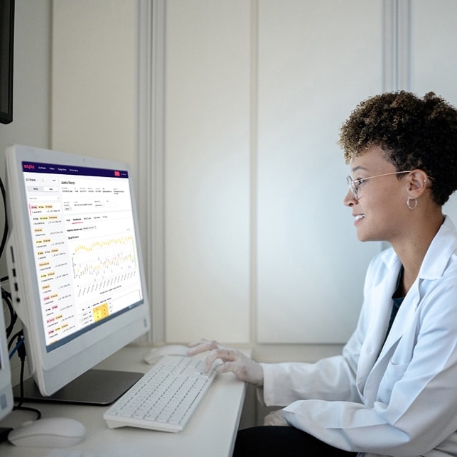 Doctor Reviewing Patient Readings at Computer
