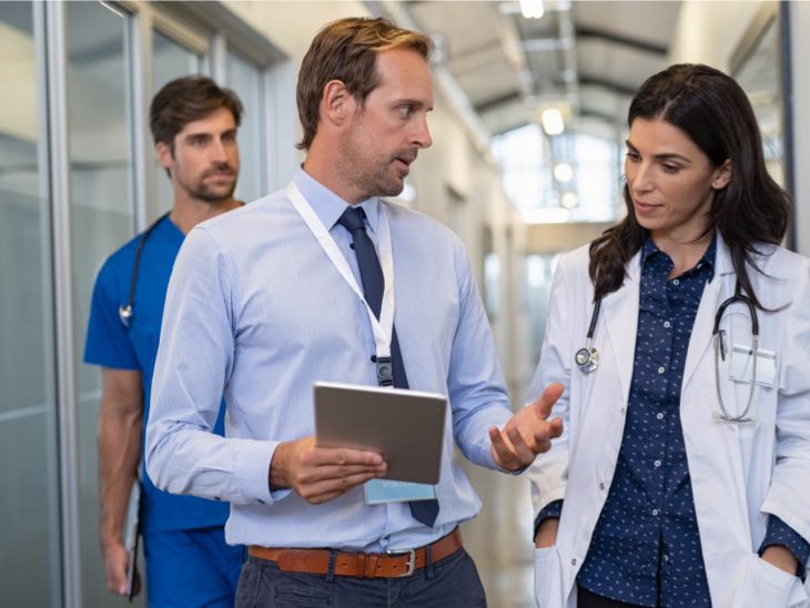 Salesman With Doctor In Hall