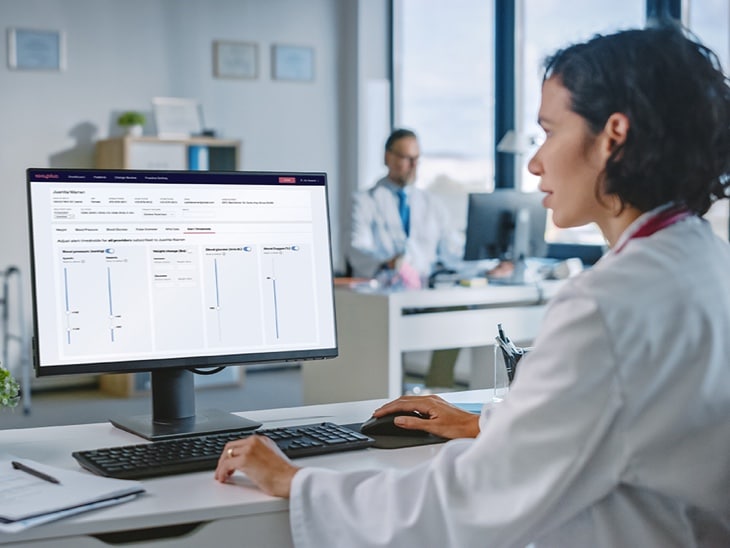 Woman At Computer With Visible Screen