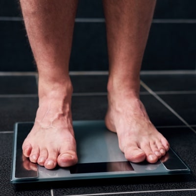 Man's feet on digital weight scale