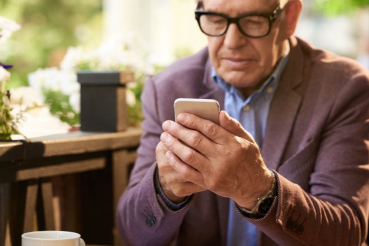 Man In Sport Coat Using Smart Phone