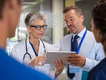Physician Reviewing Patient Readings With Specialist