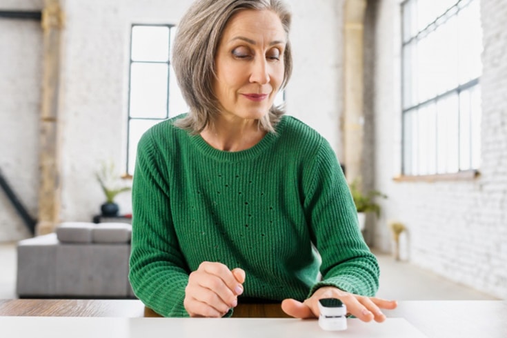 Woman Using Pulse Oximeter