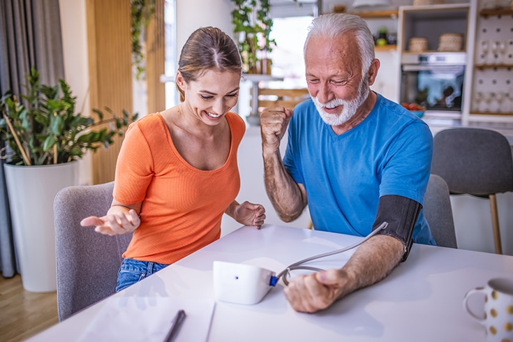 Man Taking Blood Pressure With Granddaughter