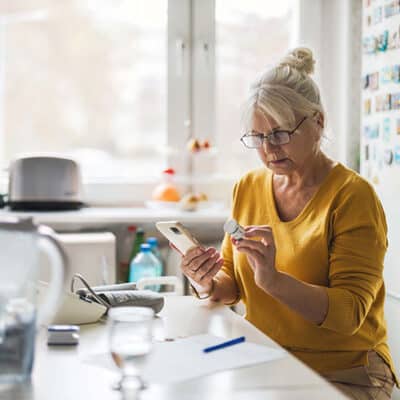 Woman Checking Medication Dosage On Phone