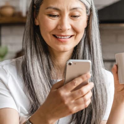 Smiling woman checking vitals on her phone