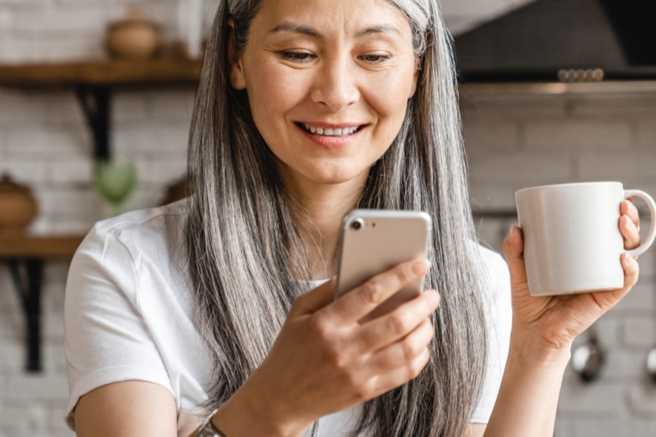 Smiling woman checking vitals on her phone